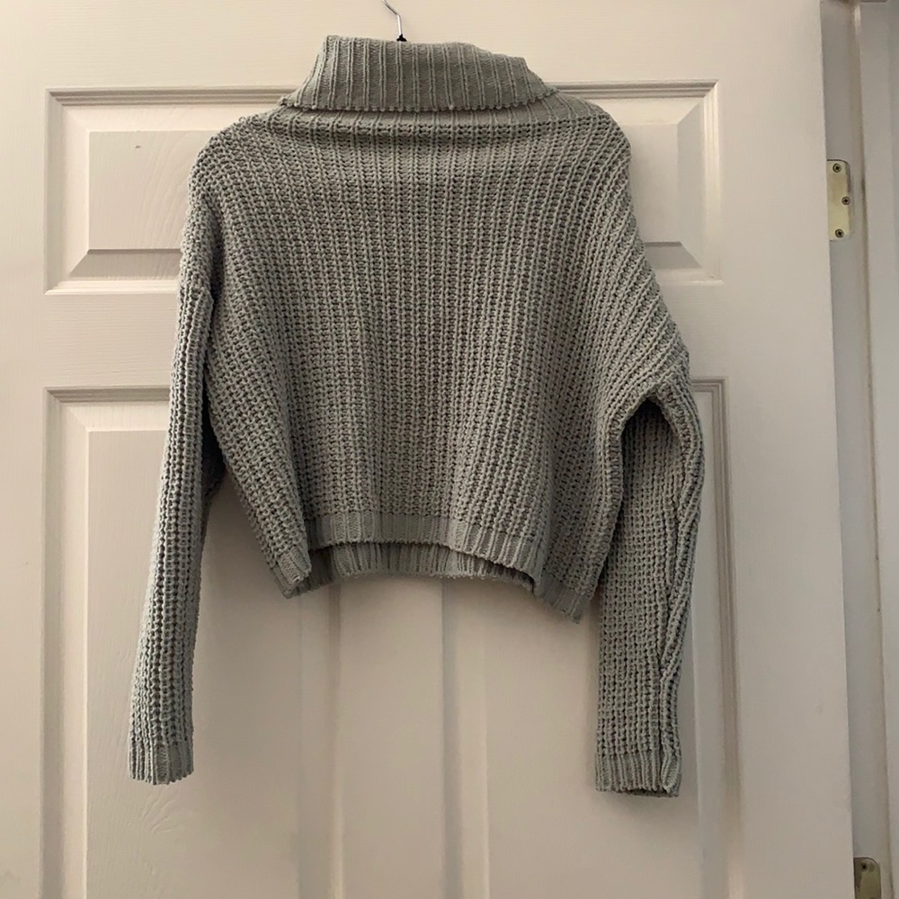 a small poof apparel turtle neck sweater